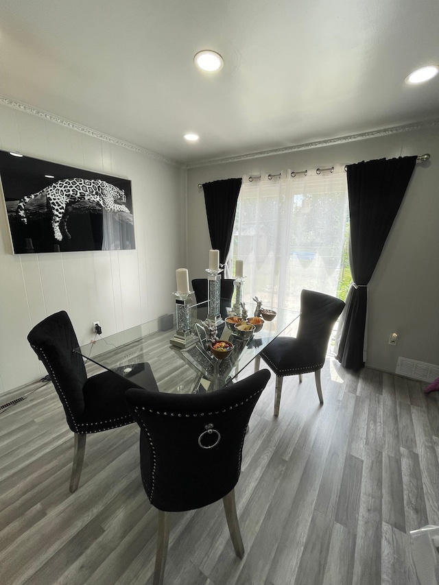 dining space featuring visible vents and wood finished floors