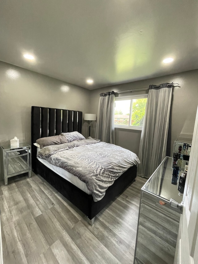 bedroom with recessed lighting and wood finished floors