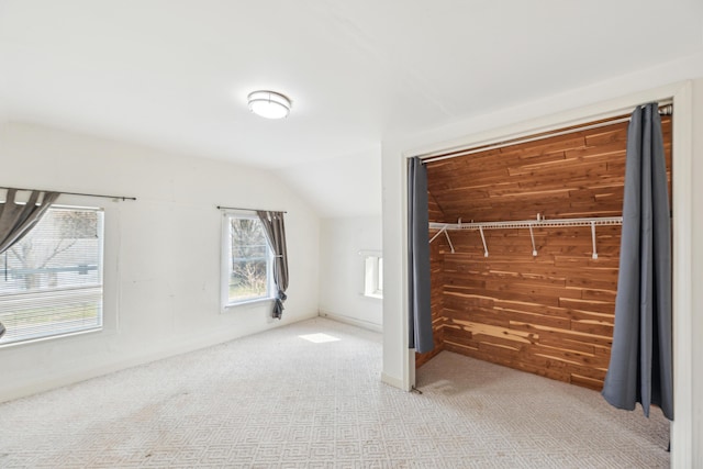 6308 E Becht Rd, Coloma, MI 49038 - unfurnished bedroom with lofted ceiling, wood walls, and carpet flooring