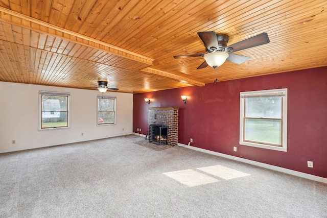 6308 E Becht Rd, Coloma, MI 49038 - unfurnished living room featuring wooden ceiling, ceiling fan, carpet, a fireplace, and baseboards