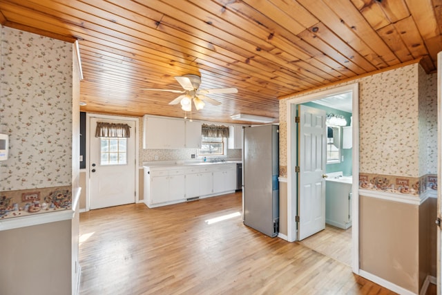 6308 E Becht Rd, Coloma, MI 49038 - kitchen featuring freestanding refrigerator, wood ceiling, wallpapered walls, white cabinets, and light countertops