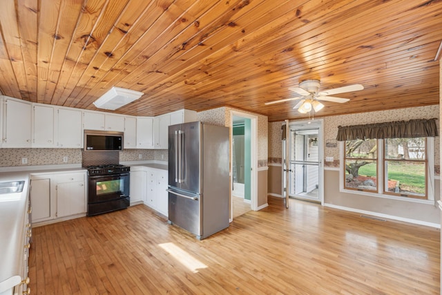 6308 E Becht Rd, Coloma, MI 49038 - kitchen with stainless steel appliances, light wood-type flooring, baseboards, light countertops, and wooden ceiling