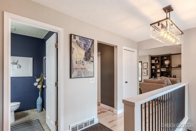 2376 Bob White Ct SE, Grand Rapids, MI 49546 - corridor with light wood finished floors, visible vents, and baseboards