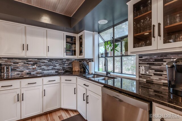 2376 Bob White Ct SE, Grand Rapids, MI 49546 - kitchen with tasteful backsplash, dark stone countertops, a sink, white cabinetry, and stainless steel dishwasher