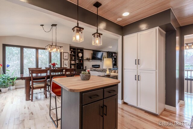2376 Bob White Ct SE, Grand Rapids, MI 49546 - kitchen featuring butcher block counters, light wood finished floors, a kitchen breakfast bar, and white cabinetry