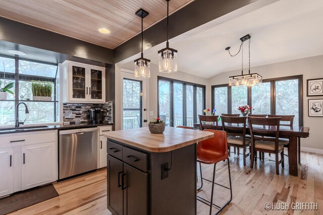 2376 Bob White Ct SE, Grand Rapids, MI 49546 - kitchen featuring stainless steel dishwasher, a kitchen breakfast bar, a sink, and a chandelier