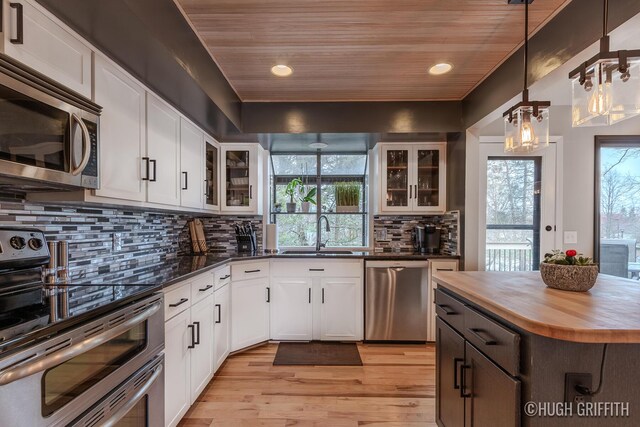 2376 Bob White Ct SE, Grand Rapids, MI 49546 - kitchen featuring a sink, butcher block countertops, appliances with stainless steel finishes, and wooden ceiling