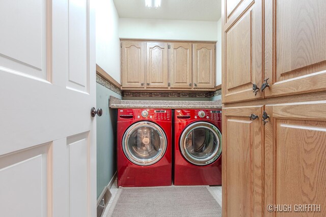 2376 Bob White Ct SE, Grand Rapids, MI 49546 - laundry room featuring washer and clothes dryer and cabinet space
