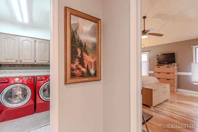 2376 Bob White Ct SE, Grand Rapids, MI 49546 - washroom with baseboards, ceiling fan, light wood-style floors, cabinet space, and washing machine and dryer