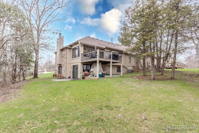 2376 Bob White Ct SE, Grand Rapids, MI 49546 - rear view of property with a yard, a deck, central air condition unit, and a chimney