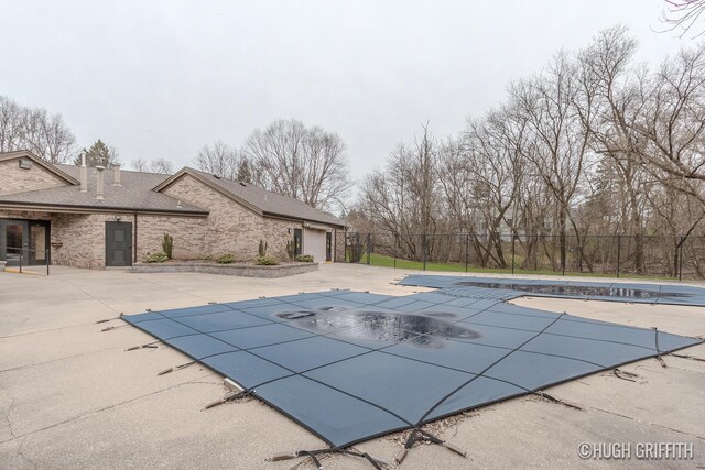 2376 Bob White Ct SE, Grand Rapids, MI 49546 - view of swimming pool with a patio area, fence, and a covered pool