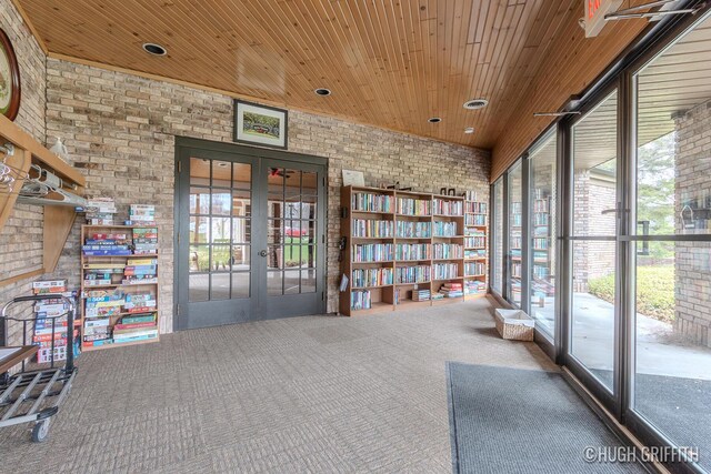 2376 Bob White Ct SE, Grand Rapids, MI 49546 - unfurnished room featuring french doors, wooden ceiling, carpet flooring, and brick wall