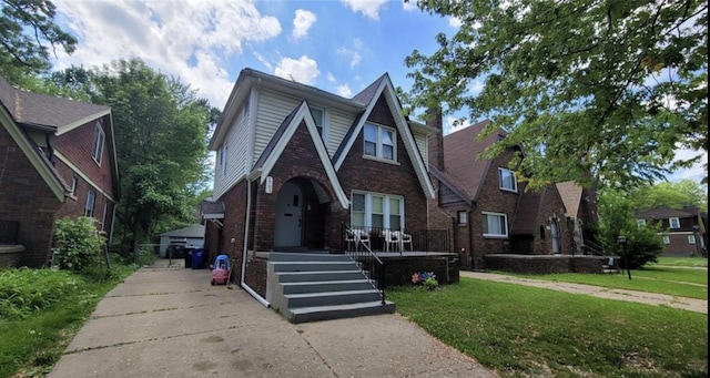 5793 Yorkshire Rd, Detroit, MI 48224 - tudor home featuring a front yard and brick siding
