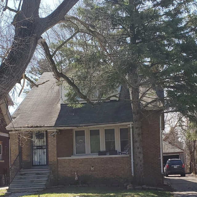 11060 Wilshire Dr, Detroit, MI 48213 - view of front of home with roof with shingles and brick siding