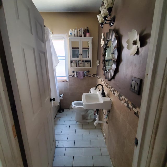 11060 Wilshire Dr, Detroit, MI 48213 - half bath with tile patterned flooring, tile walls, a sink, and toilet