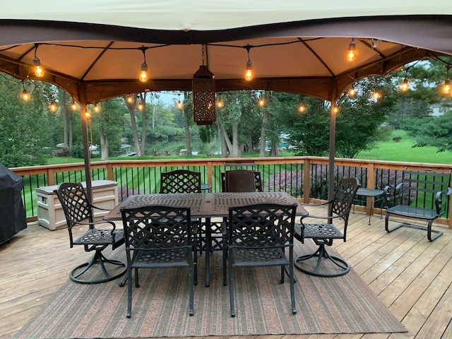 5280 Inverrary Ln, Commerce Twp, MI 48382 - deck at night featuring a gazebo and outdoor dining area