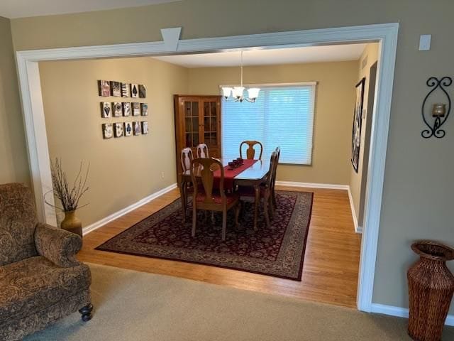 5280 Inverrary Ln, Commerce Twp, MI 48382 - dining area featuring a chandelier, wood finished floors, and baseboards