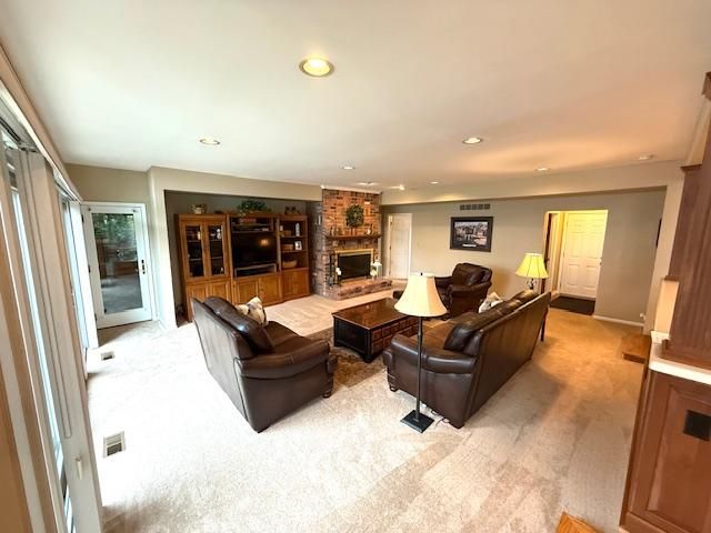 5280 Inverrary Ln, Commerce Twp, MI 48382 - living room featuring light colored carpet, a fireplace, recessed lighting, and baseboards