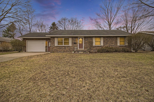single story home with an attached garage, driveway, a front lawn, and brick siding