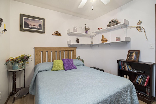 bedroom featuring wood finished floors and a ceiling fan