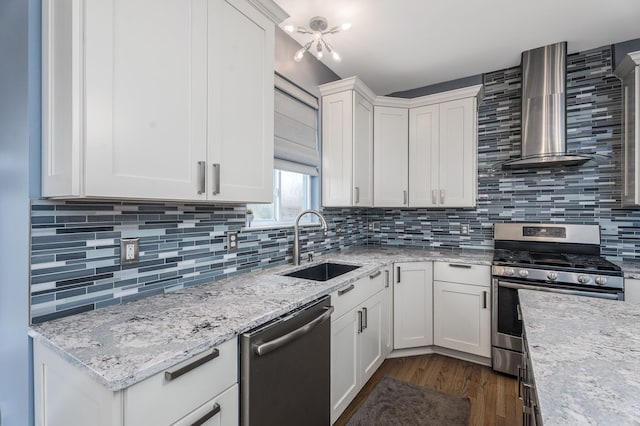 3885 Silver Charm Ln, Howell, MI 48843 - kitchen featuring stainless steel appliances, a sink, wall chimney range hood, dark wood-style flooring, and white cabinets