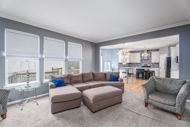 3885 Silver Charm Ln, Howell, MI 48843 - living area featuring a chandelier, crown molding, baseboards, and light wood-style flooring