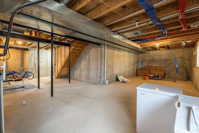 3885 Silver Charm Ln, Howell, MI 48843 - unfinished basement featuring white refrigerator and stairs