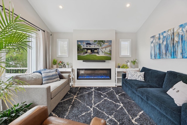 11449 Sunset Blvd, Pinckney, MI 48169 - living room featuring vaulted ceiling, a glass covered fireplace, and recessed lighting
