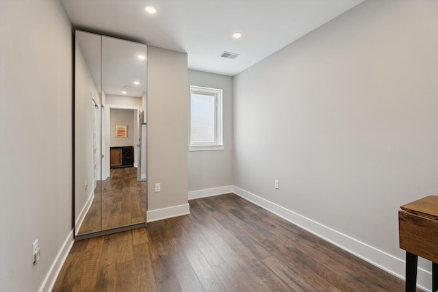 11449 Sunset Blvd, Pinckney, MI 48169 - unfurnished bedroom featuring dark wood-style flooring, baseboards, and recessed lighting