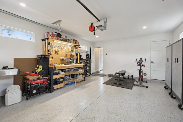 11449 Sunset Blvd, Pinckney, MI 48169 - garage featuring a workshop area, recessed lighting, and a garage door opener