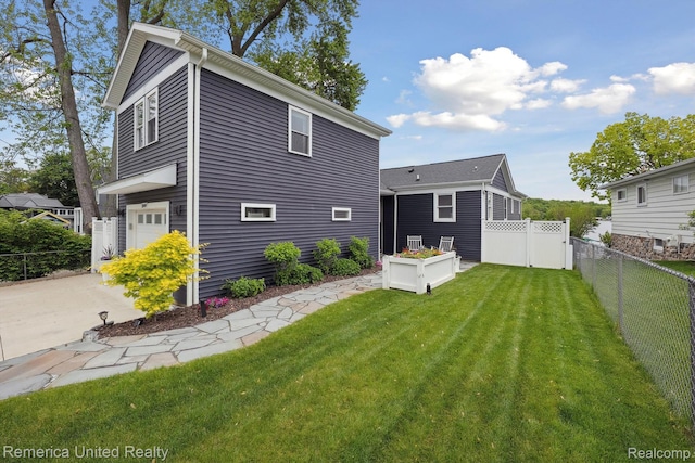 11449 Sunset Blvd, Pinckney, MI 48169 - rear view of house with a garage and concrete driveway