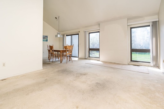 interior space with baseboards, a wealth of natural light, and high vaulted ceiling