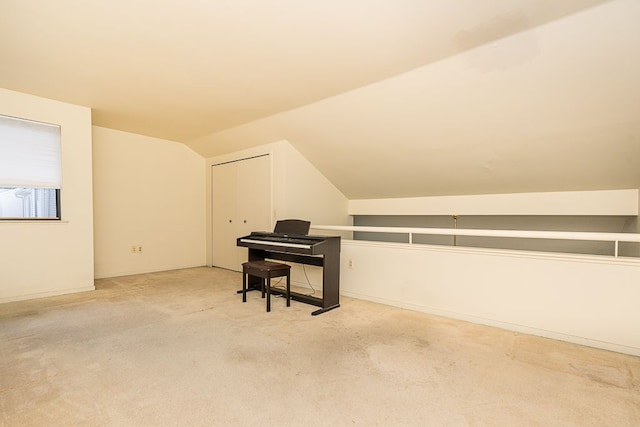 additional living space featuring lofted ceiling and carpet