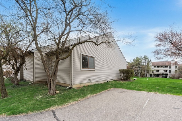 view of side of home featuring a lawn