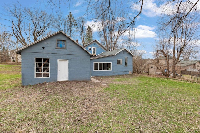 rear view of house featuring a yard