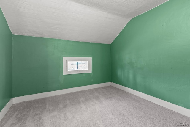 bonus room featuring carpet flooring, baseboards, a textured ceiling, and lofted ceiling