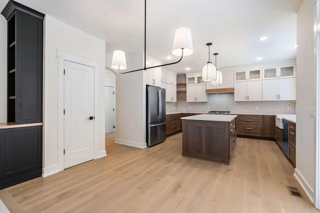 kitchen with stainless steel appliances, tasteful backsplash, light wood finished floors, and recessed lighting