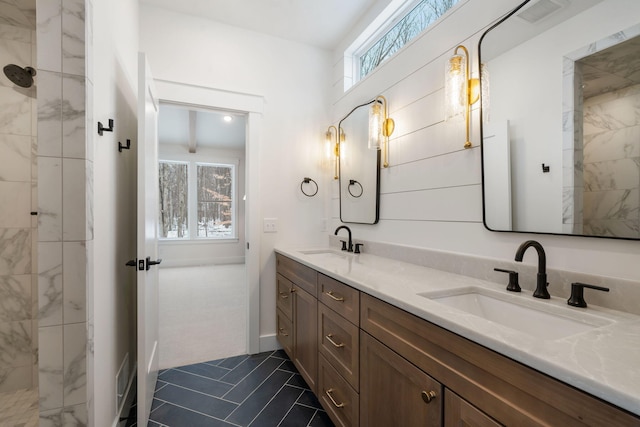 full bathroom featuring double vanity, tiled shower, and tile patterned flooring