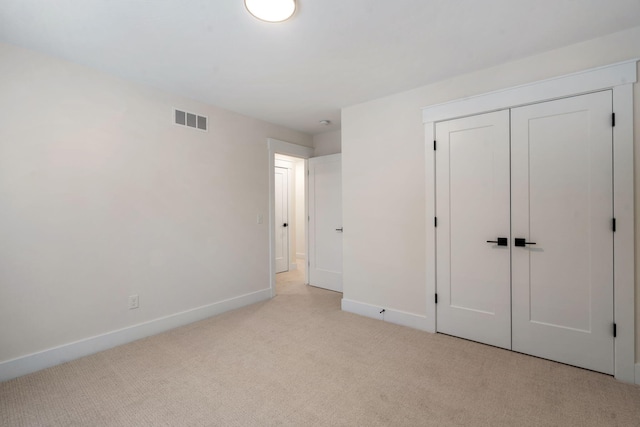 unfurnished bedroom with carpet flooring, baseboards, and a closet