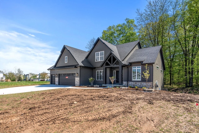 craftsman house featuring stone siding, roof with shingles, driveway, and board and batten siding