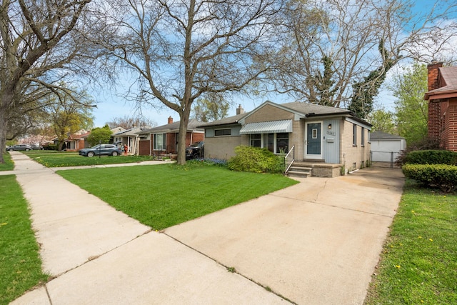 view of front facade with brick siding, a chimney, and a front yard