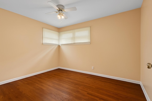 unfurnished room with a ceiling fan, baseboards, and wood finished floors