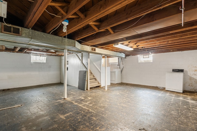 basement with visible vents, stairs, washer / clothes dryer, and tile patterned floors