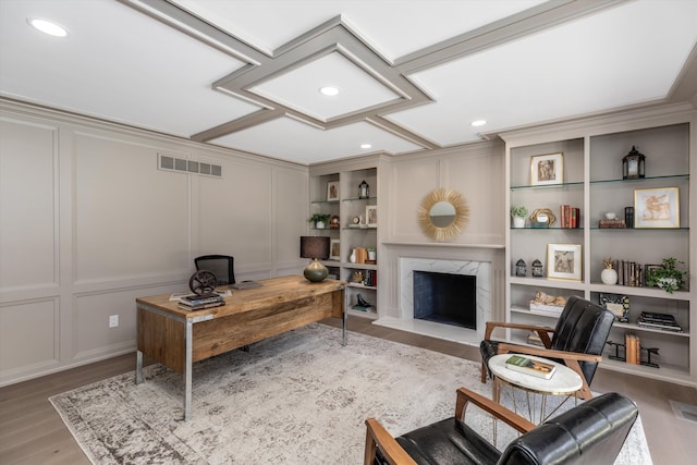 245 Chestnut Cir, Bloomfield Hills, MI 48304 - home office featuring wood finished floors, a decorative wall, a premium fireplace, built in shelves, and recessed lighting
