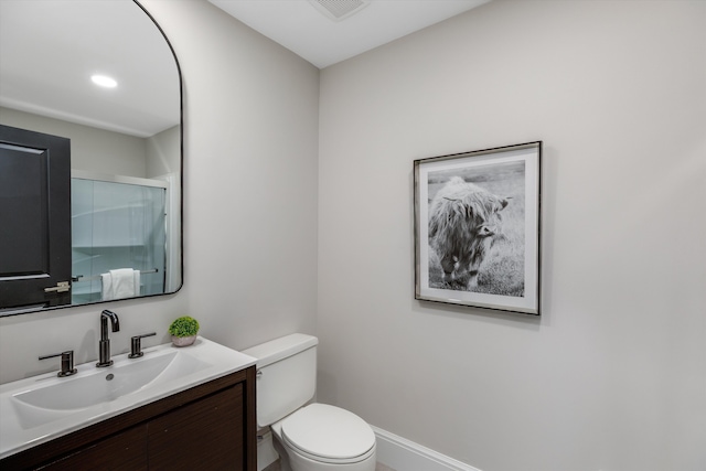 245 Chestnut Cir, Bloomfield Hills, MI 48304 - bathroom featuring toilet, vanity, a shower with shower door, and baseboards