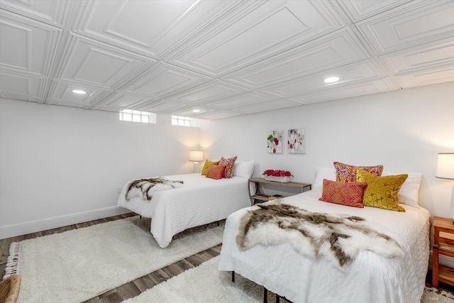 bedroom featuring recessed lighting, an ornate ceiling, wood finished floors, and baseboards