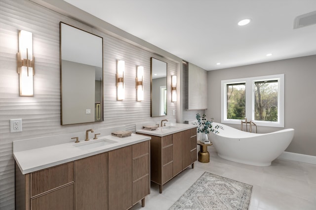 245 Chestnut Cir, Bloomfield Hills, MI 48304 - full bathroom featuring two vanities, a freestanding tub, decorative backsplash, recessed lighting, and tile patterned floors