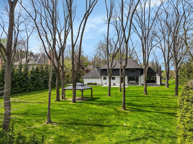 view of home's community with a gazebo and a yard