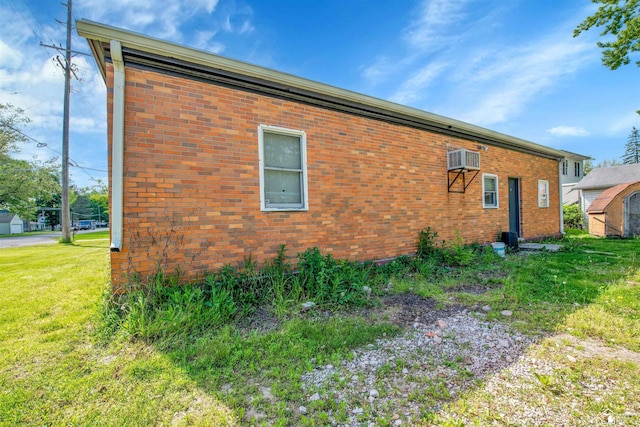 12800 Matthews St, Carleton, MI 48117 - view of home's exterior featuring a lawn, a wall mounted air conditioner, and brick siding