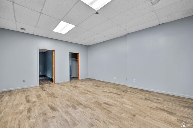 12800 Matthews St, Carleton, MI 48117 - unfurnished bedroom with a paneled ceiling, wood finished floors, and baseboards